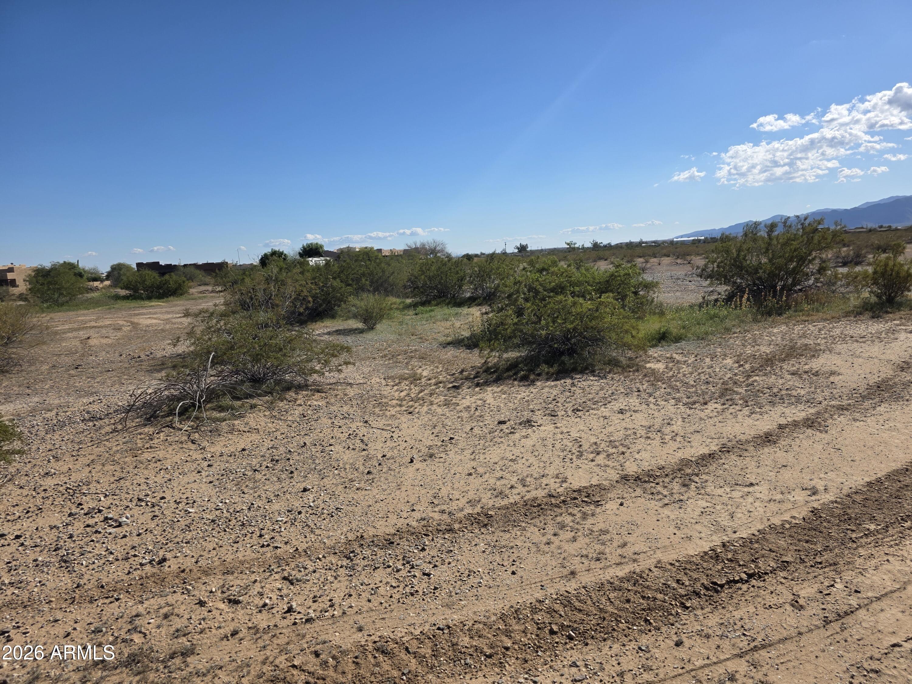 19300 West Roadrunner Road Wittmann, AZ 85361 - Photo 87 of 102 a view of a dry yard with mountains in the background
