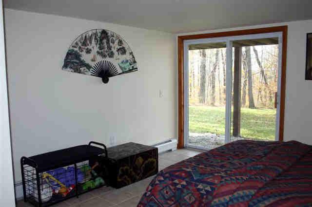 417 Fred Snow Road Becket, MA 01223 - Photo 6 of 10 a bedroom with a bed and a window