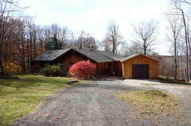 417 Fred Snow Road Becket, MA 01223 - Photo 8 of 10 a front view of a house with a yard and garage