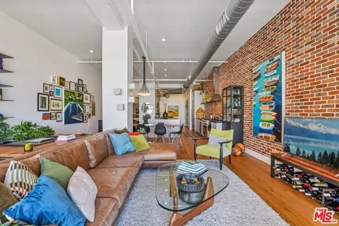 a living room with furniture and a book shelf
