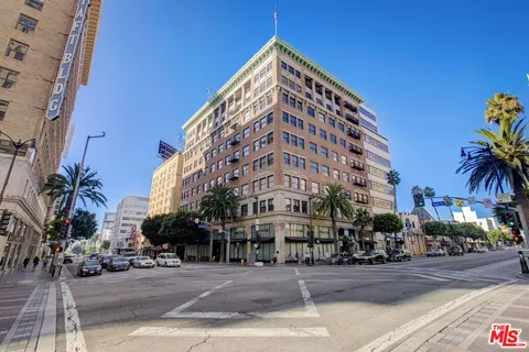 a view of a tall building next to a road