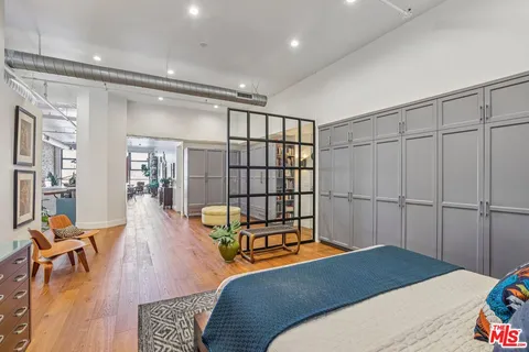 a dining room with furniture a rug and a potted plant