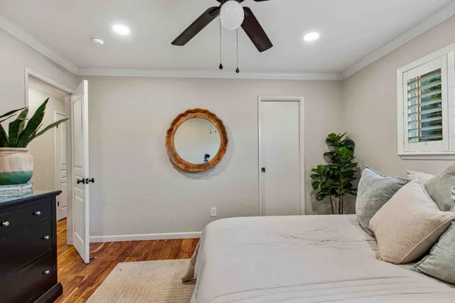 a bedroom with a bed and a potted plant