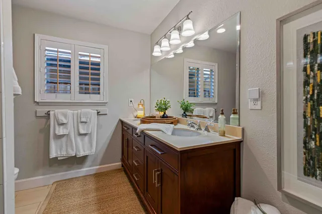 a bathroom with a sink a vanity and a mirror