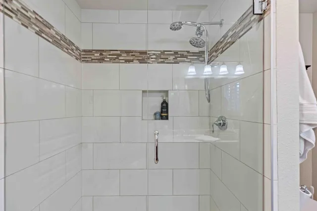 a bathroom with a shower and vanity