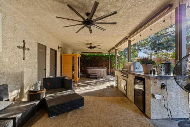 a living room with furniture a flat screen tv and a large window