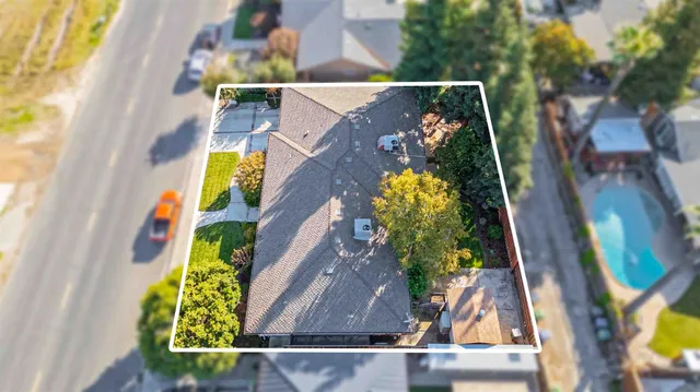 an aerial view of a house with a swimming pool