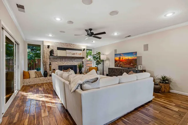 a living room with furniture a fireplace and a flat screen tv
