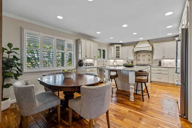 a dining room with furniture and wooden floor