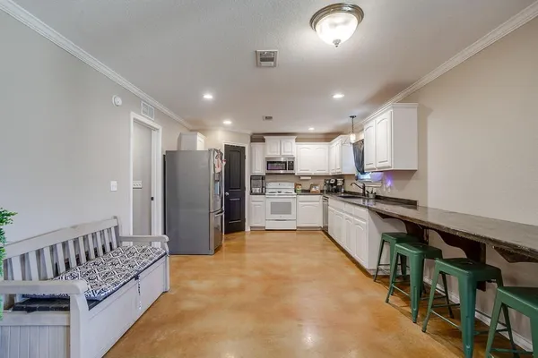a kitchen with refrigerator and cabinets