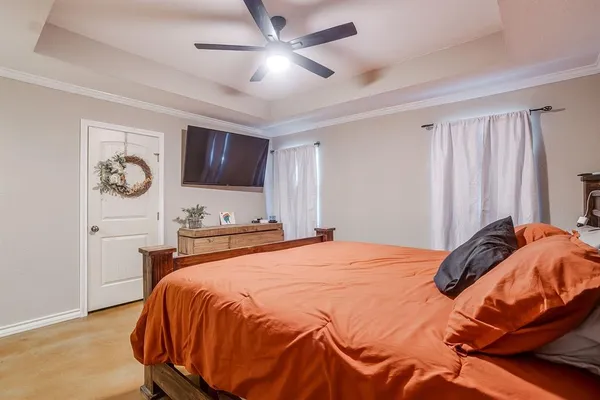 a bedroom with a bed and a chandelier