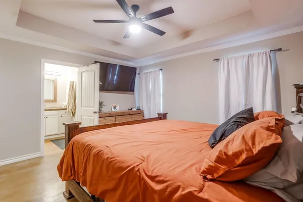 a bedroom with a bed and a mirror