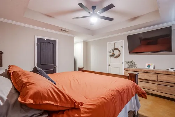 a bedroom with a bed and a flat screen tv