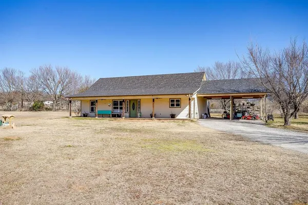 a front view of house with yard and outdoor seating
