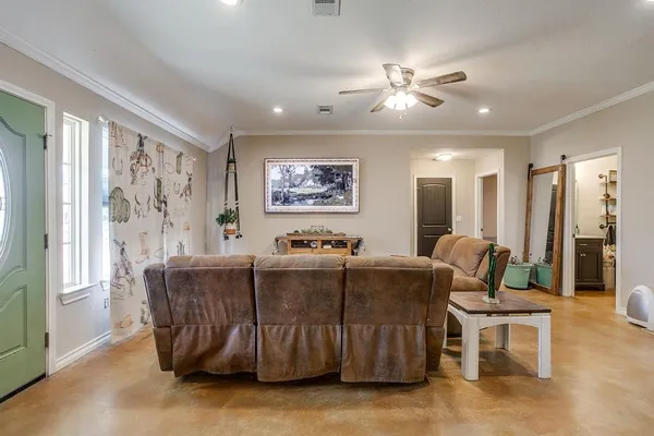 a living room with furniture and a large window