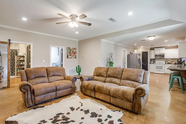 a living room with furniture and kitchen view