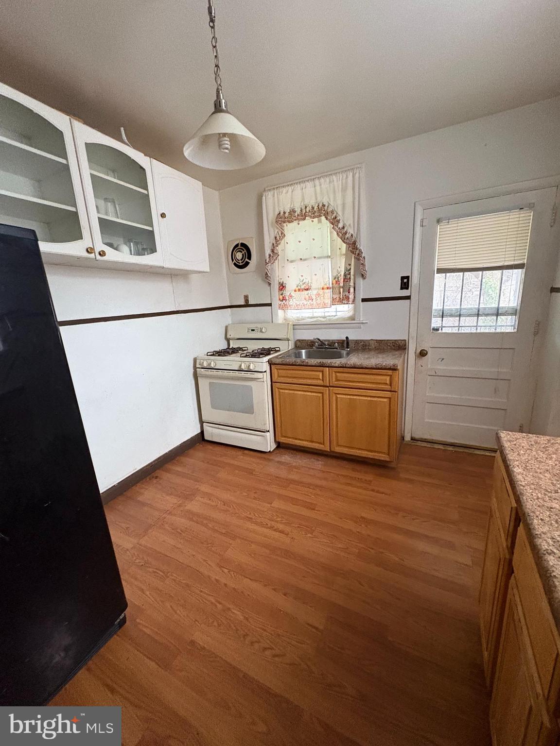 511 North Gross Street Philadelphia, PA 19151 - Photo 4 of 10 a kitchen with stainless steel appliances granite countertop a sink and a stove