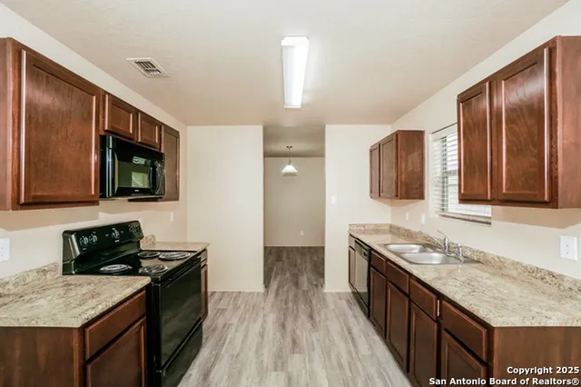 a kitchen with stainless steel appliances granite countertop a stove and a sink