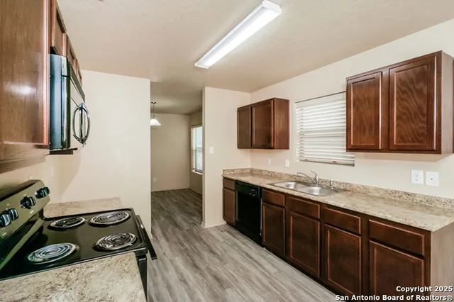 a kitchen with stainless steel appliances granite countertop a stove and a sink