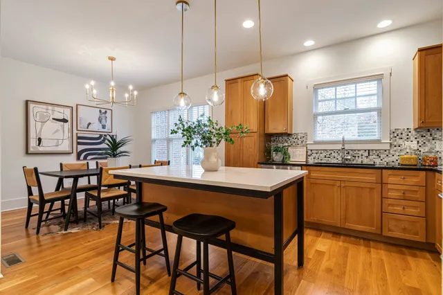 a large kitchen with a table and chairs in it