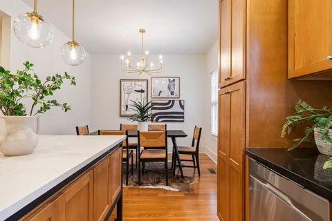 a view of a dining room with furniture and chandelier