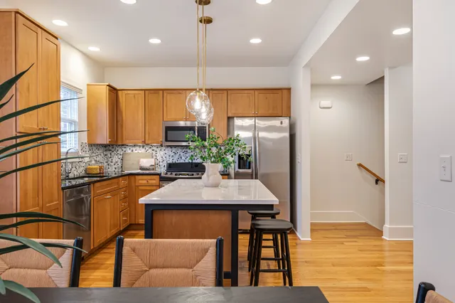 a kitchen with stainless steel appliances granite countertop sink refrigerator and microwave
