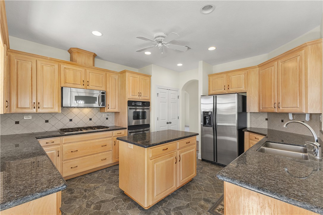 2120 Hohenwalde School Road Brenham, TX 77833 - Photo 13 of 30 a kitchen with stainless steel appliances granite countertop a sink refrigerator and cabinets