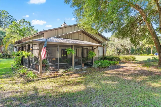a view of a house with backyard and porch