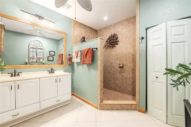 a kitchen with kitchen island granite countertop a stove top oven sink and cabinets