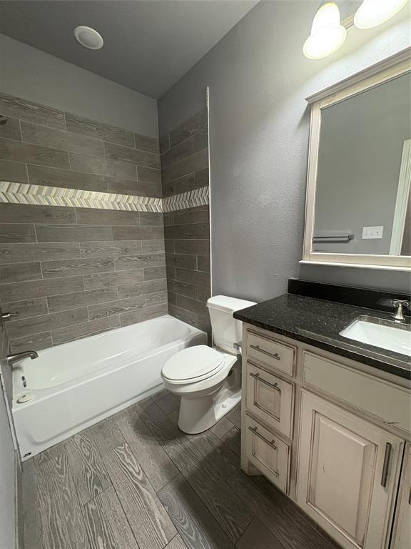 216 Cleveland Street, Unit B Cleburne, TX 76031 - Photo 15 of 26 a bathroom with a sink a toilet and shower