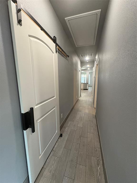 216 Cleveland Street, Unit B Cleburne, TX 76031 - Photo 17 of 26 a view of a hallway with wooden floor