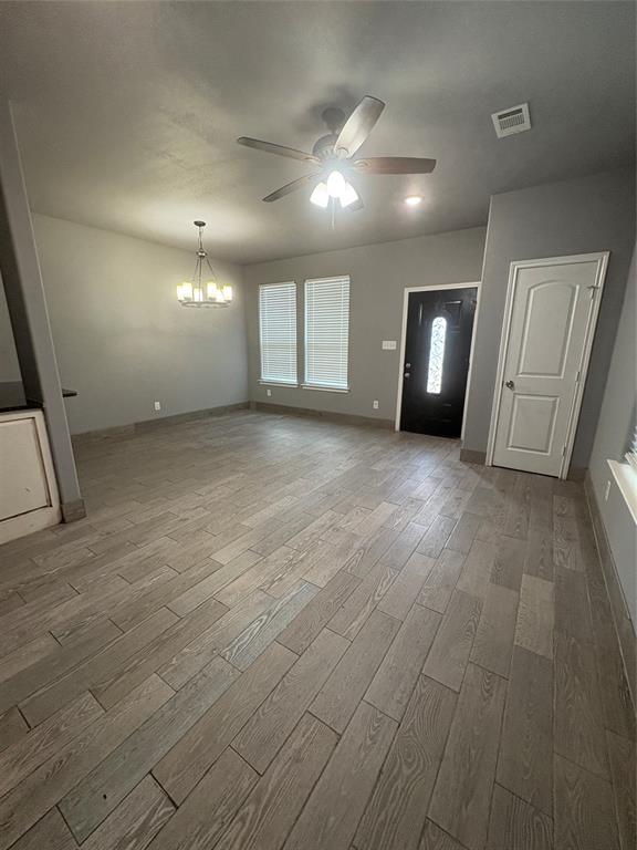 216 Cleveland Street, Unit B Cleburne, TX 76031 - Photo 3 of 26 a view of a big room with wooden floor and windows