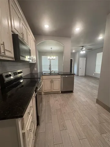 a kitchen with stainless steel appliances granite countertop a stove and a sink
