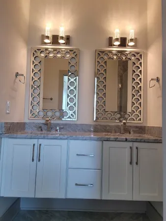 a bathroom with sinks granite and a mirror