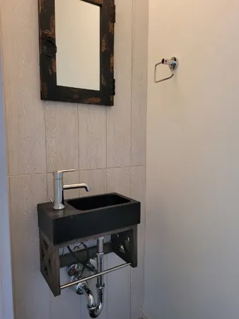a room with a wooden floor and a mirror