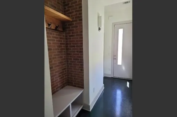 a view of hallway with wooden floor