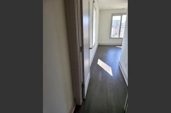 a view of a hallway with wooden floor