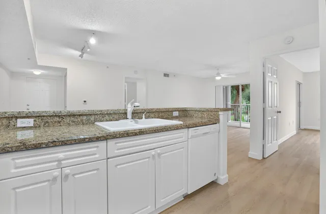 a bathroom with a granite countertop sink and a