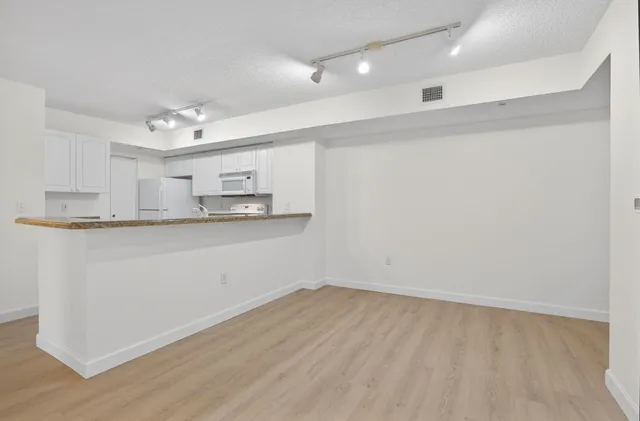 a view of a kitchen with marble kitchen and sink