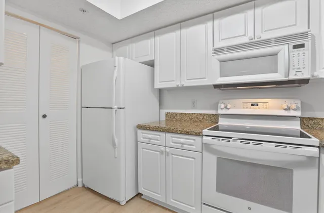 a kitchen with cabinets and stainless steel appliances