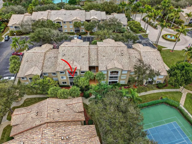 an aerial view of multiple houses with a yard