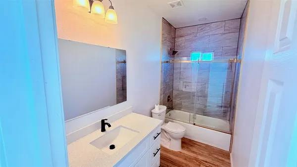 a bathroom with a bathtub and a sink