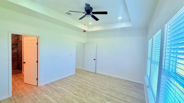 a view of room with hardwood floor and ceiling fan