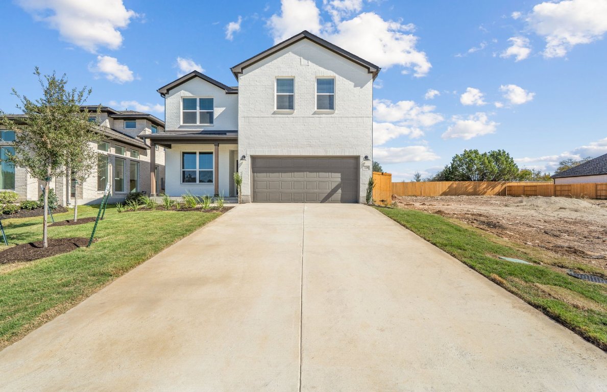 a view of house with yard and street view