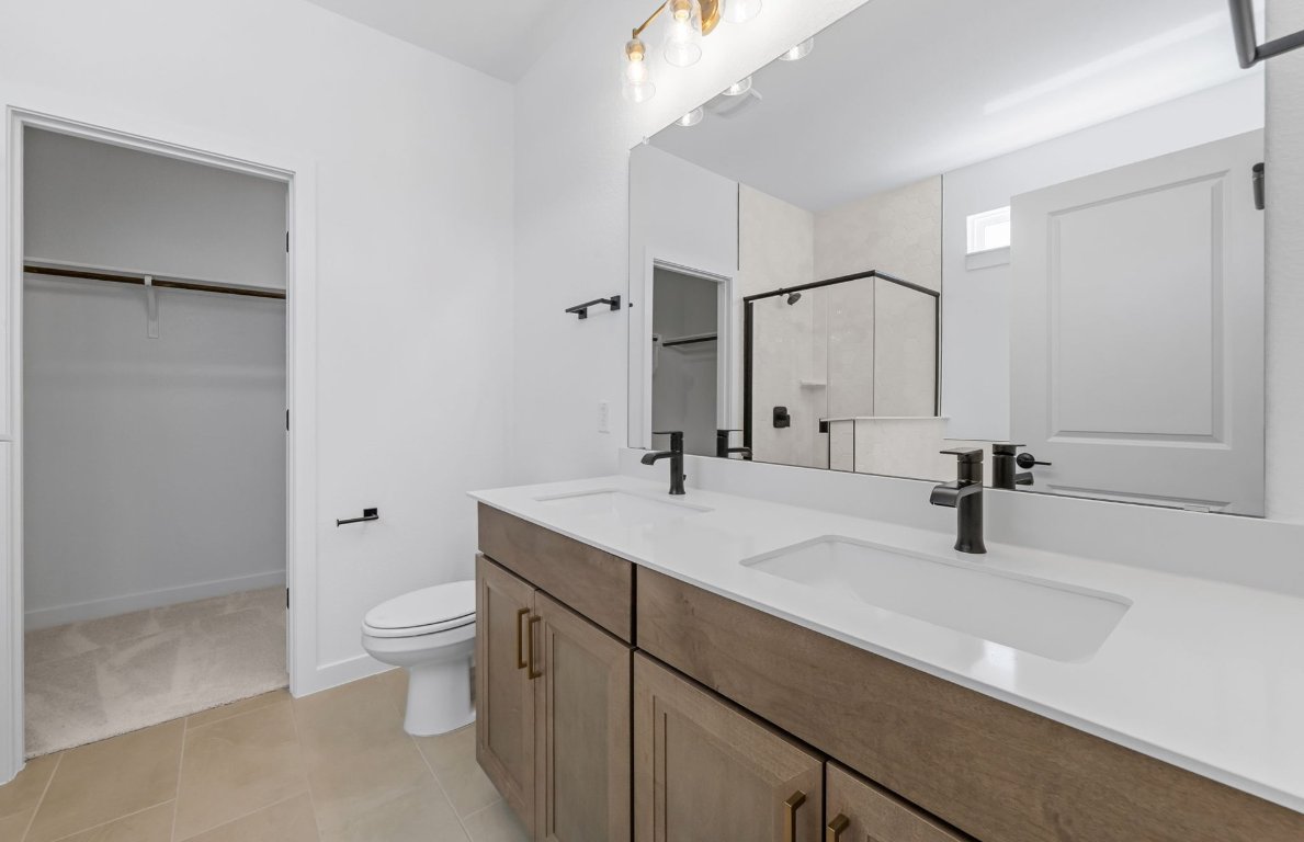 125 Adlai Avenue Georgetown, TX 78633 - Photo 17 of 32 a bathroom with a sink a toilet and a large mirror