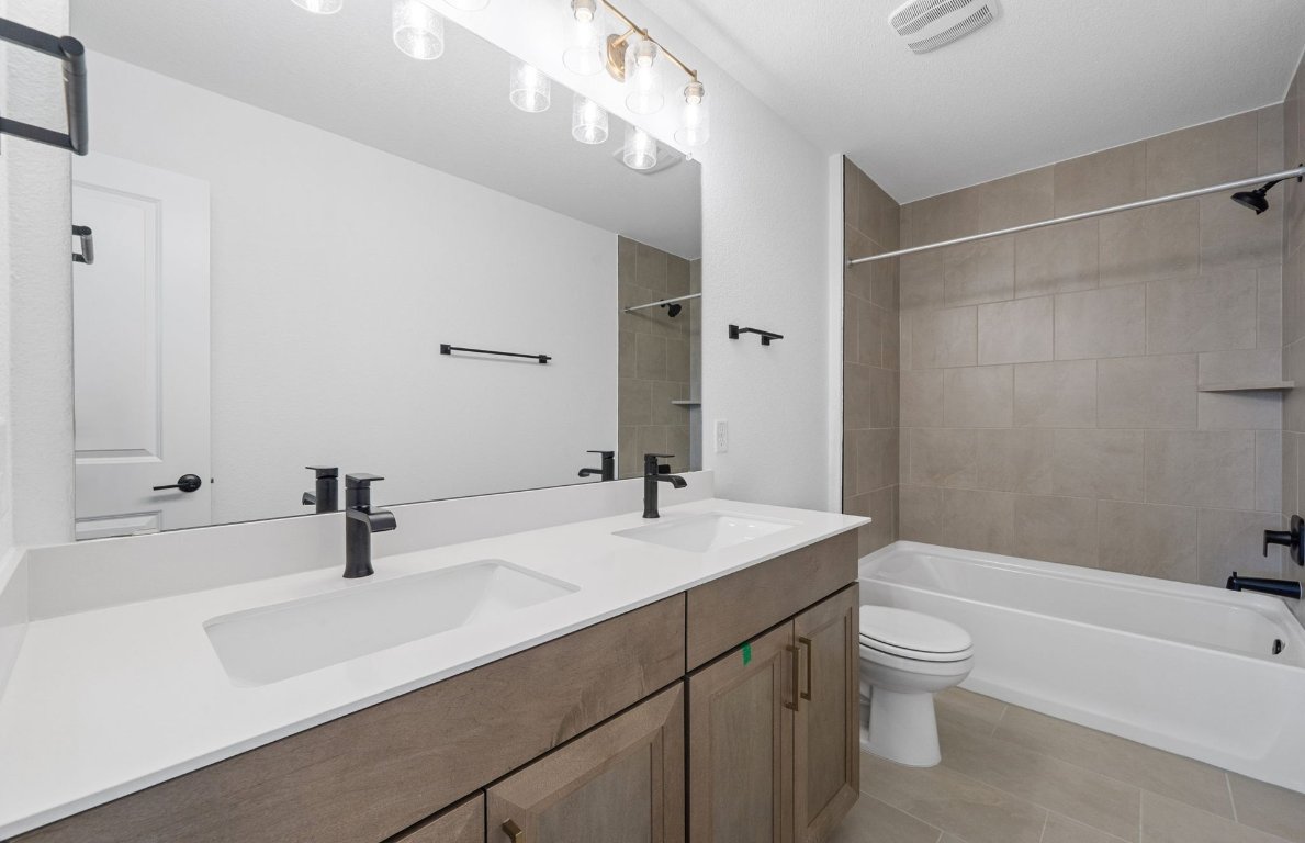 125 Adlai Avenue Georgetown, TX 78633 - Photo 24 of 32 a bathroom with a sink a toilet and shower