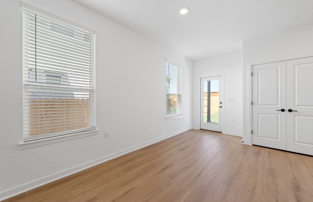125 Adlai Avenue Georgetown, TX 78633 - Photo 10 of 32 a view of an empty room with wooden floor and a window