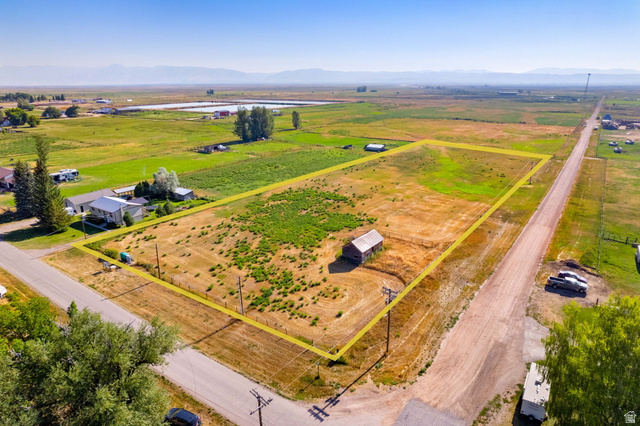 161 South 2nd Street East Paris, ID 83261 - Photo 9 of 28 Expansive lot featuring a single structure, surrounding green fields, and distant mountains