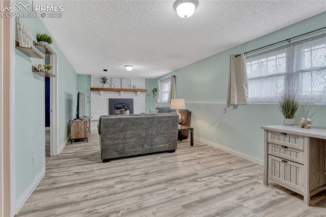 7108 Chippewa Road Colorado Springs, CO 80915 - Photo 7 of 40 Lower level rec room with gas fireplace!