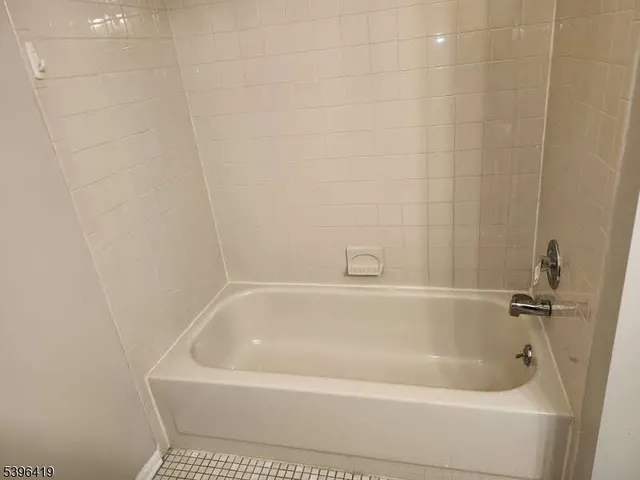 a white bath tub and shower